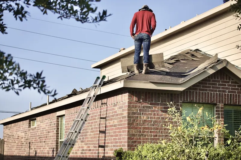 Professional roofer working on a residential roof in Blue Valley Acres